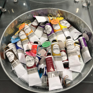 Oil paint tubes in a galvaized steel bucket
